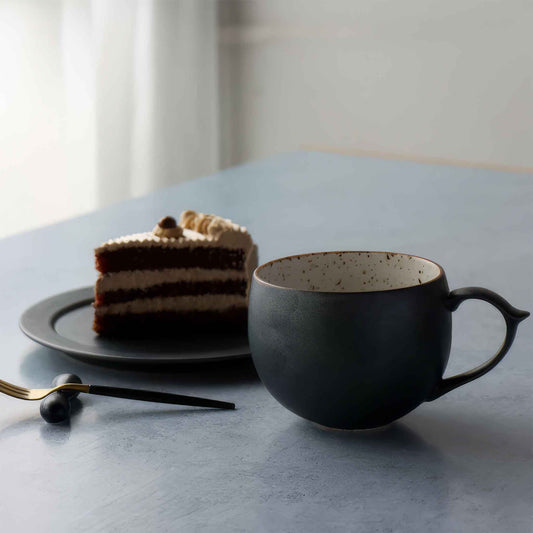 Handcrafted black and white wabi-sabi ceramic mug with saucer, Arita ware.