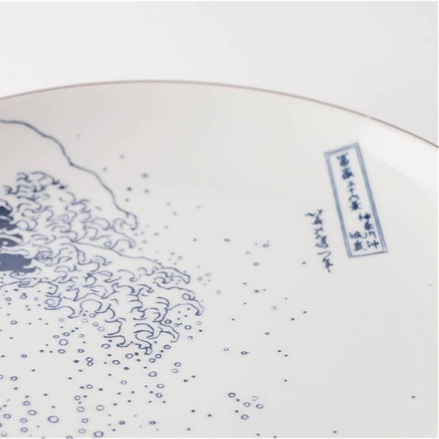 Ceramic plate with blue wave design on a white background