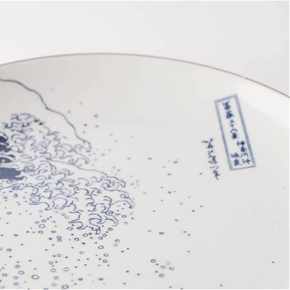 Ceramic plate with blue wave design on a white background