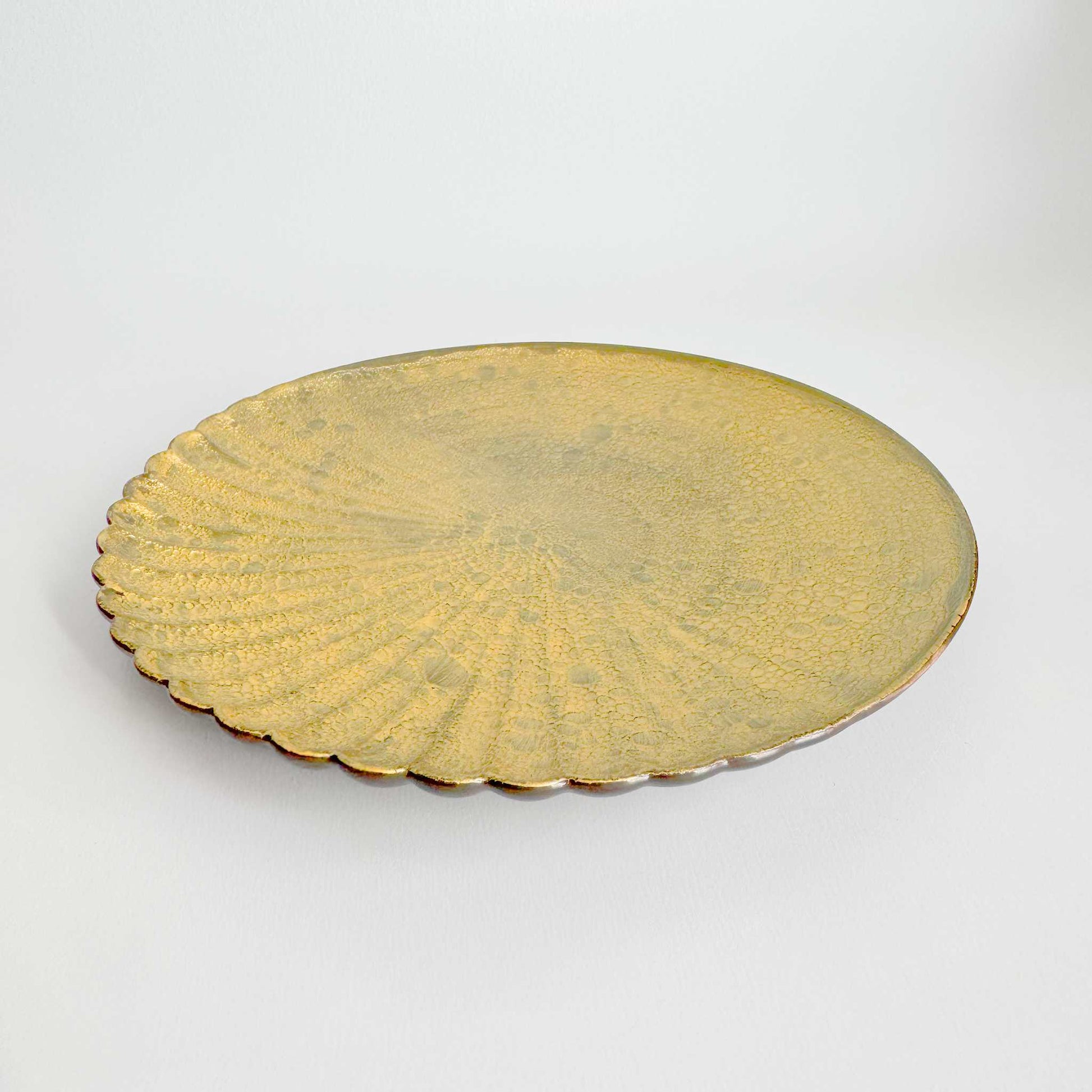 Gold decorative plate on a white background