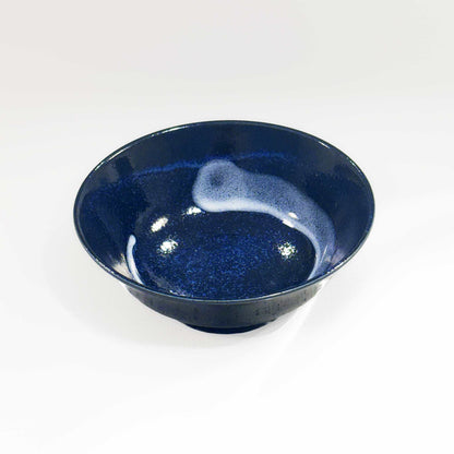 A dark blue, speckled glaze Mino Ware Porcelain Ramen Bowl, made from high-quality ceramic materials, sits on a plain white background.