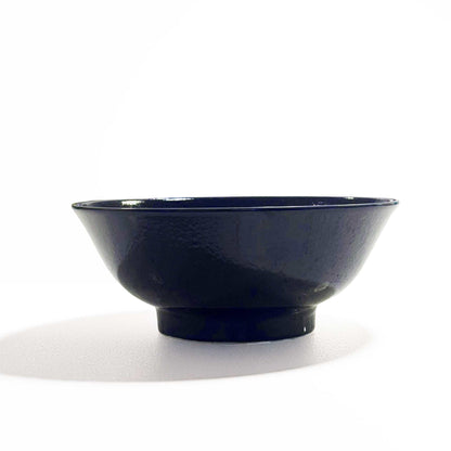 A dark blue, hand-painted Mino ware porcelain ramen bowl with a subtle, speckled glaze, set against a clean white background.