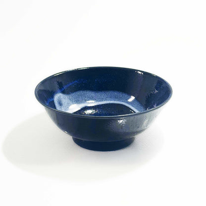 A dark blue, hand-painted Mino ware Porcelain Ramen Bowl with a speckled glaze, set against a white background.