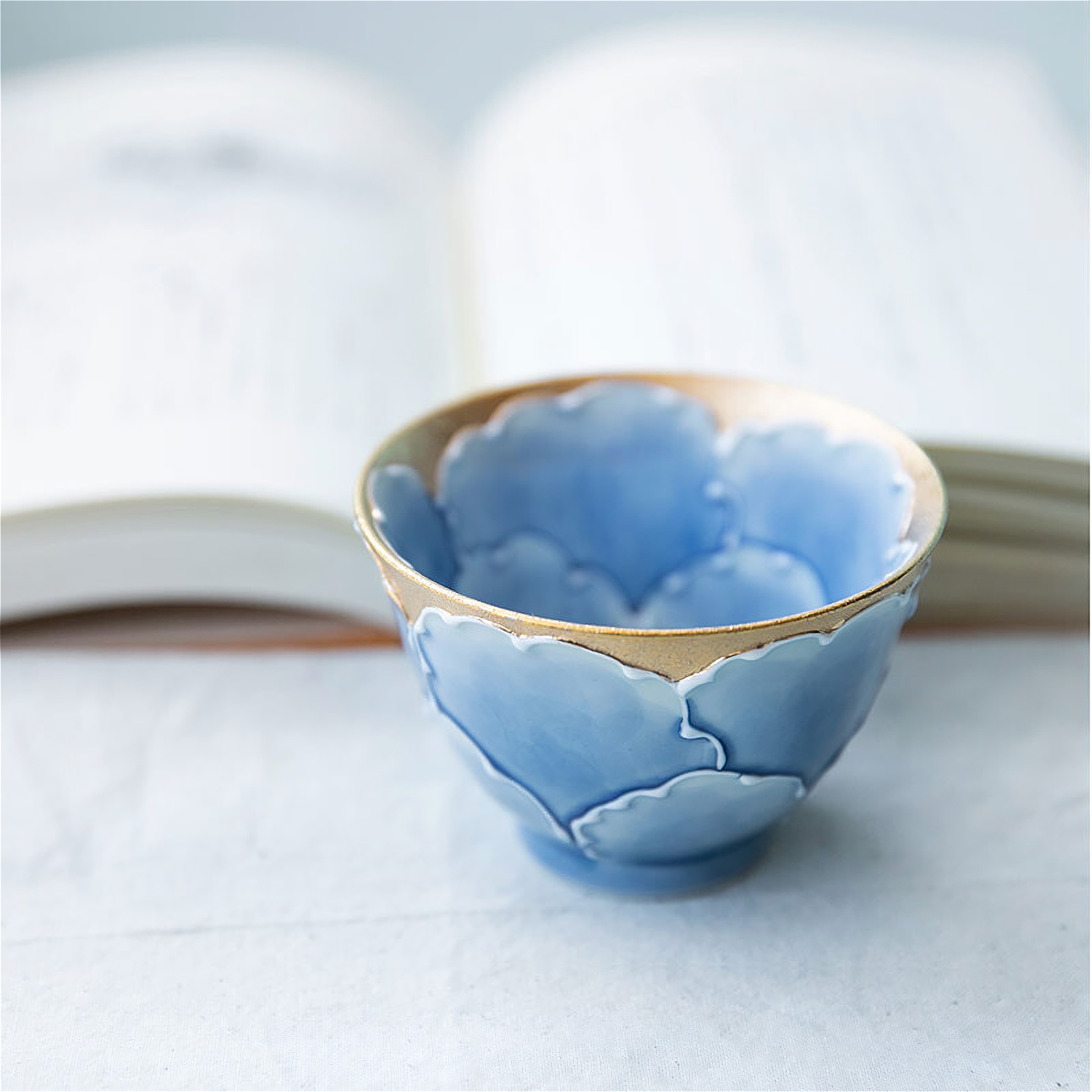 A delicate, hand-painted peony motif adorns this classic blue-and-white Arita ware tea cup, made by the renowned Bunzai Kiln.