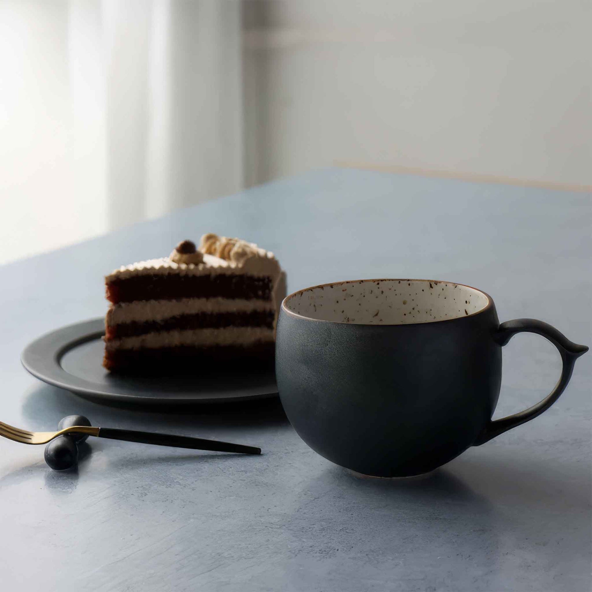 Handcrafted black and white wabi-sabi ceramic mug with saucer, Arita ware.