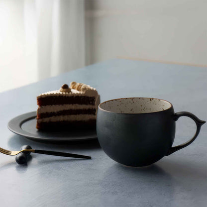 Handcrafted black and white wabi-sabi ceramic mug with saucer, Arita ware.