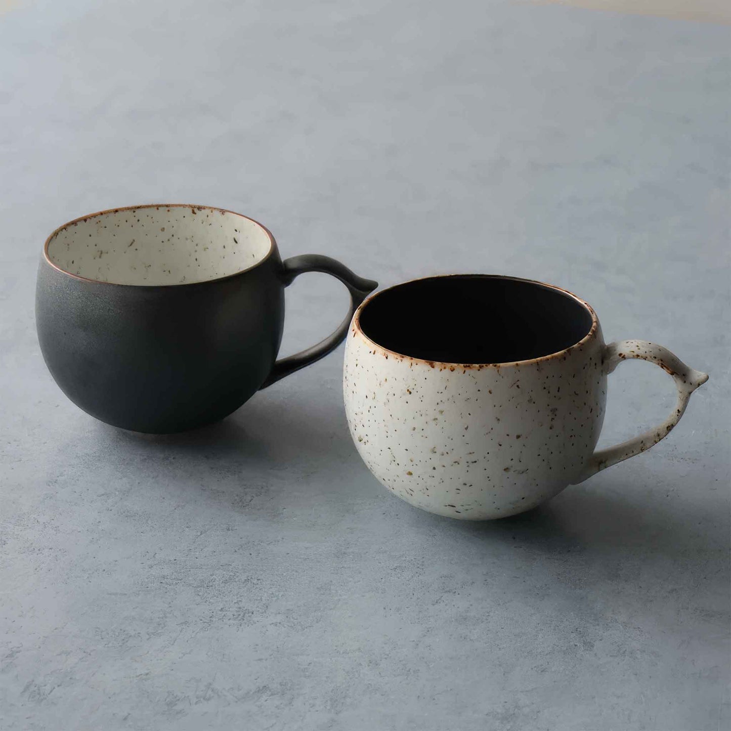 Handcrafted black and white wabi-sabi ceramic mug, Arita ware.