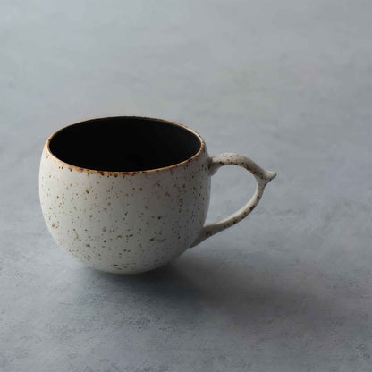 Handcrafted in Arita, Japan, this black and white mug with a unique, imperfect design embodies the wabi-sabi philosophy.