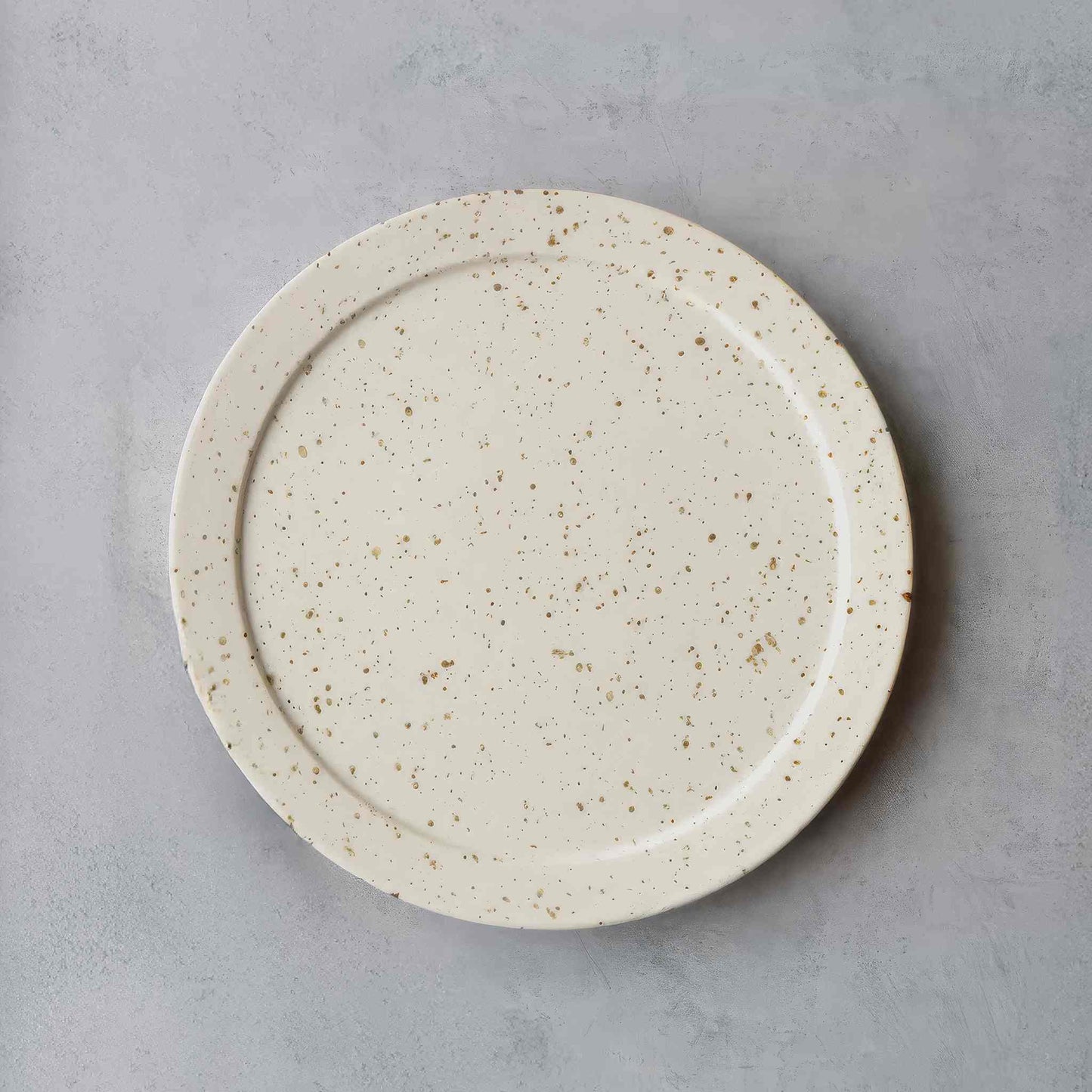 Handmade black and white plate with speckled glaze, evoking Arita ware's traditional Japanese porcelain.