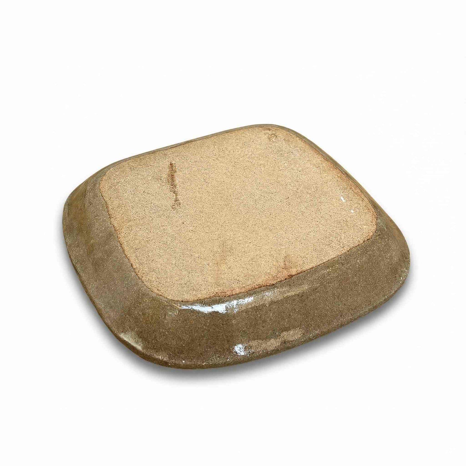 A handcrafted, square-shaped plate with a natural, earthy tone, made from slipware by Japanese ceramicist Momoko Shiohata.