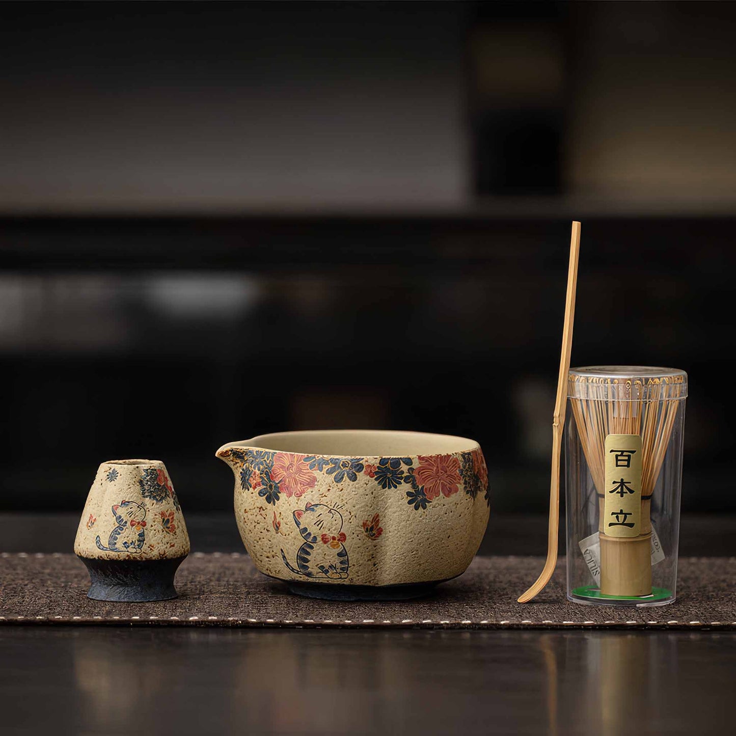 A handcrafted, blue and white flint red matcha bowl set with traditional Japanese-style design, including a matcha whisk and scoop.