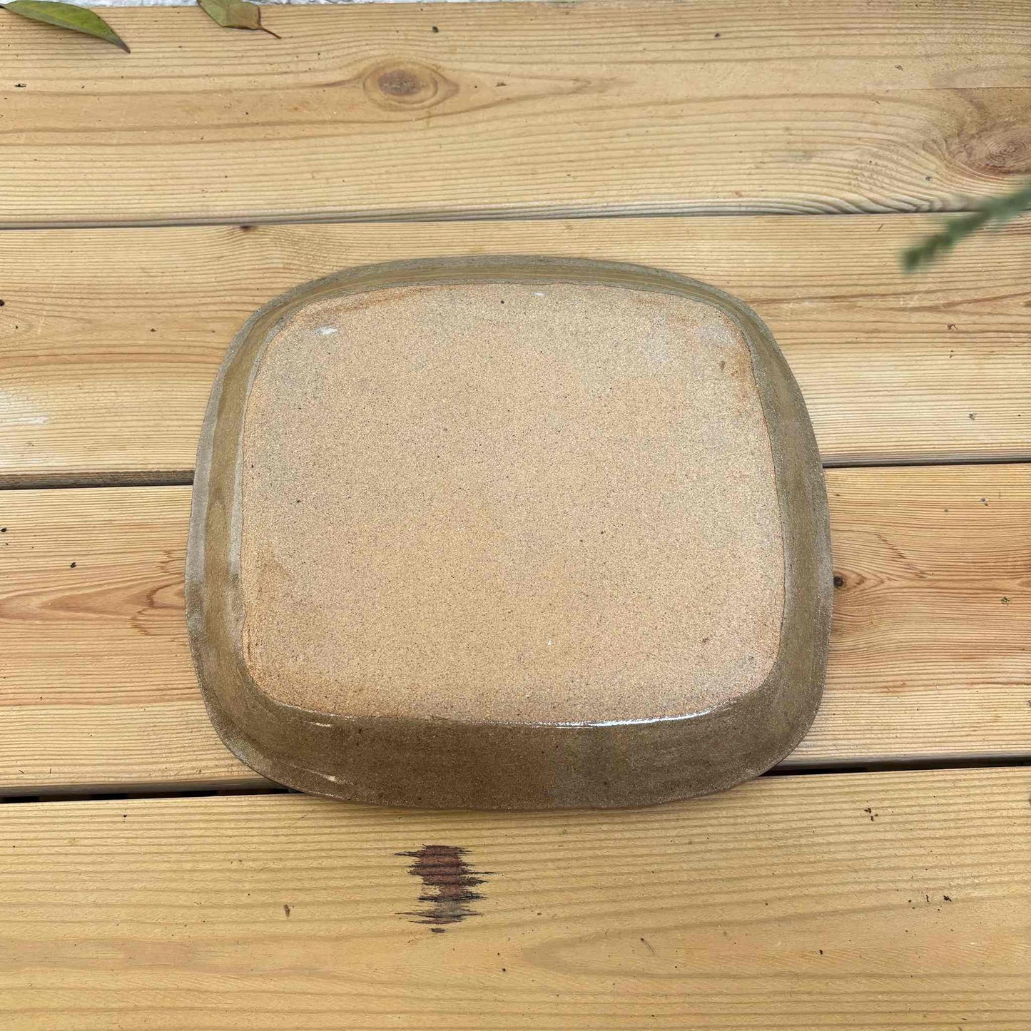 Handmade square plate with unique, hand-applied surface patterns in a neutral, earthy tone, made by Japanese ceramicist Momoko Shiohata.