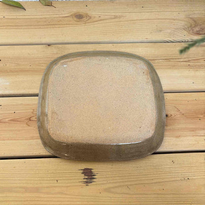 Handmade square plate with unique, hand-applied surface patterns in a neutral, earthy tone, made by Japanese ceramicist Momoko Shiohata.