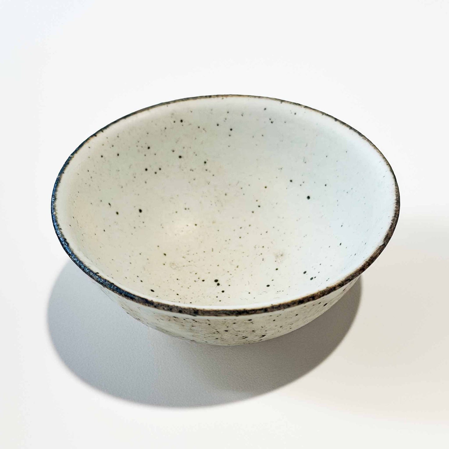 Handmade V-Shape Bowl by Takashi Sogo in white kohiki glaze, set against a neutral background.
