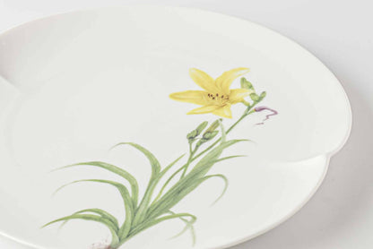 A white, delicate, and hand-painted 8-inch plate with a yellow daisy design.